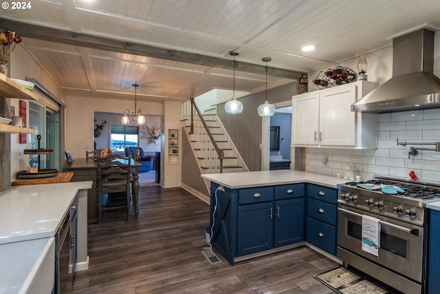 kitchen featuring range with two ovens, blue cabinets, wall chimney exhaust hood, white cabinets, and dark wood-type flooring