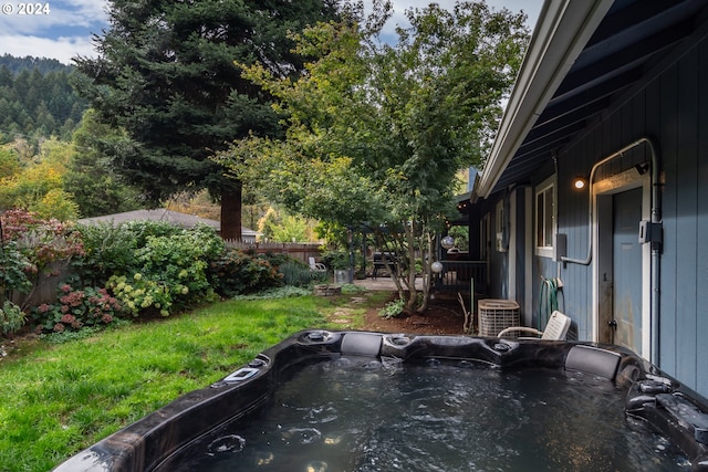 view of yard featuring a hot tub and central AC unit