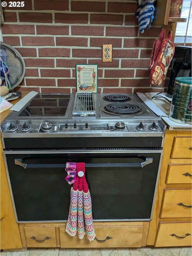 details with backsplash and black electric range