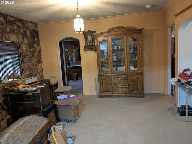 dining space featuring carpet flooring and a textured ceiling