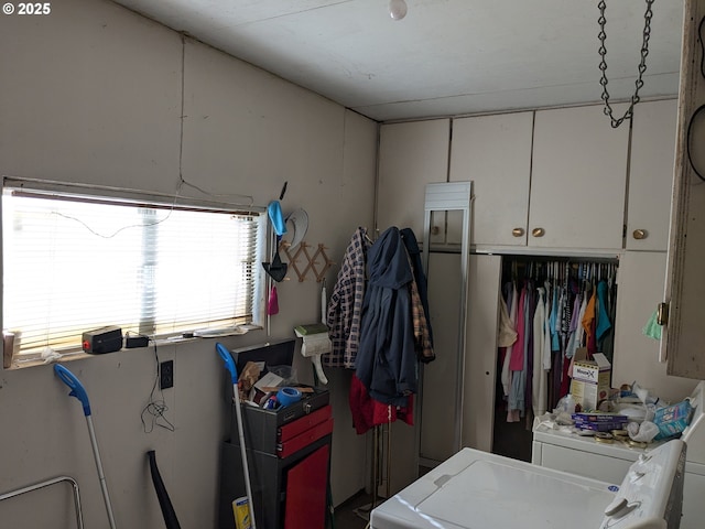 washroom with cabinets and washer and clothes dryer