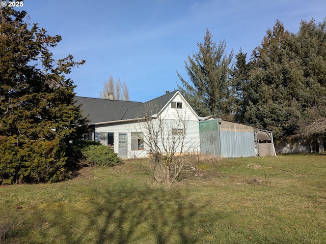 view of side of property with a lawn