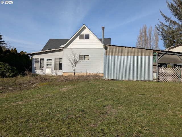 back of property featuring a lawn