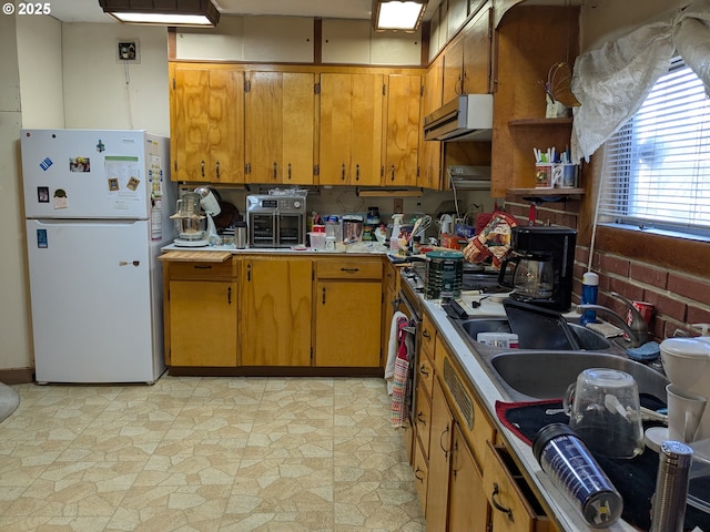 kitchen with sink and white refrigerator