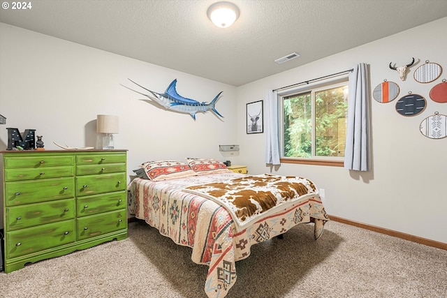 carpeted bedroom featuring a textured ceiling