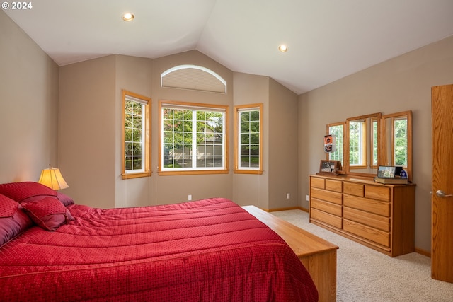 bedroom featuring light colored carpet and lofted ceiling