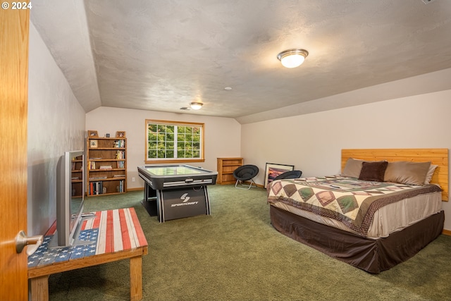 bedroom with dark carpet and lofted ceiling