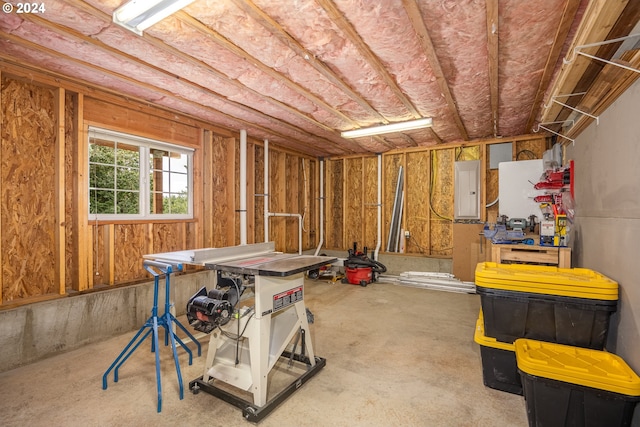 basement with electric panel and a workshop area