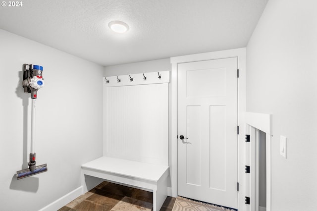 mudroom featuring a textured ceiling