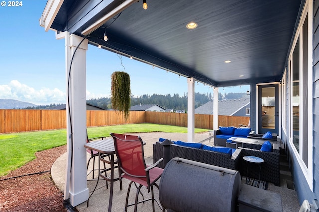 view of patio / terrace featuring a mountain view and an outdoor living space