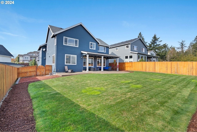 rear view of house featuring a patio area and a lawn