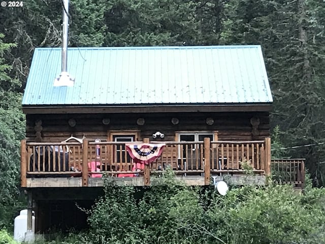 rear view of property with a wooden deck