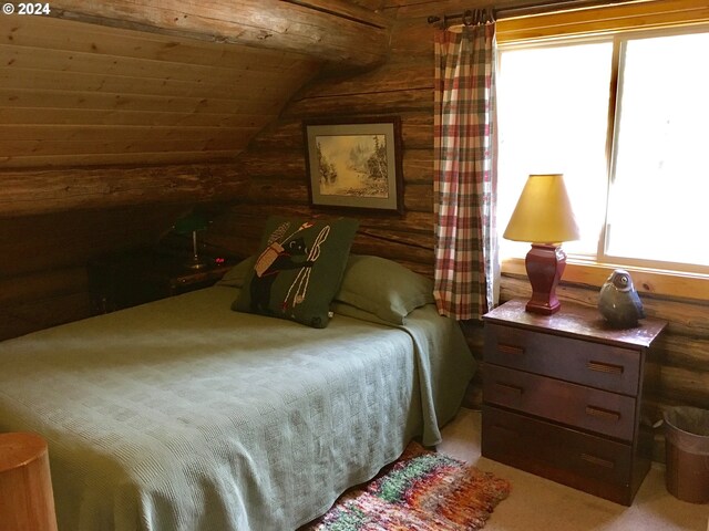 60020 Wilderness Rd, Joseph, OR 97846 - carpeted bedroom with log walls and lofted ceiling