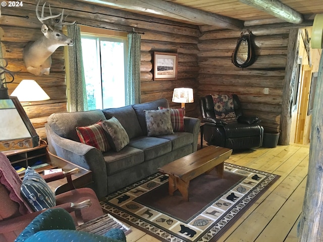 60020 Wilderness Rd, Joseph, OR 97846 - living area featuring rustic walls, hardwood / wood-style flooring, and beamed ceiling