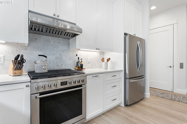 kitchen featuring stainless steel appliances, under cabinet range hood, white cabinets, and light countertops
