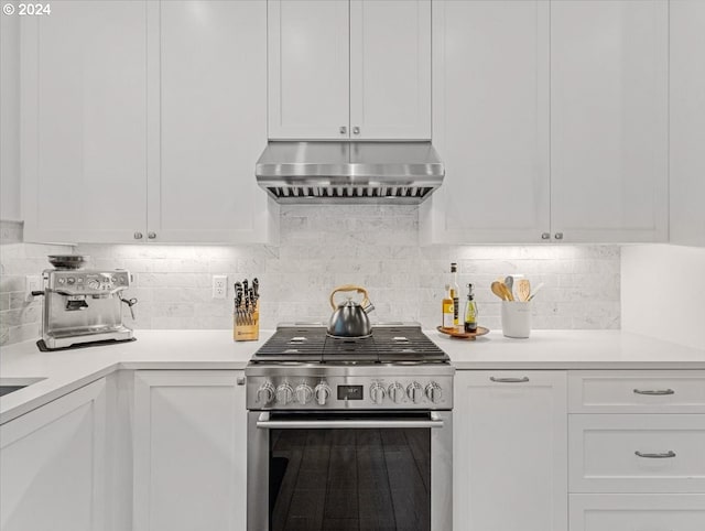 kitchen featuring stainless steel gas stove, white cabinetry, and under cabinet range hood