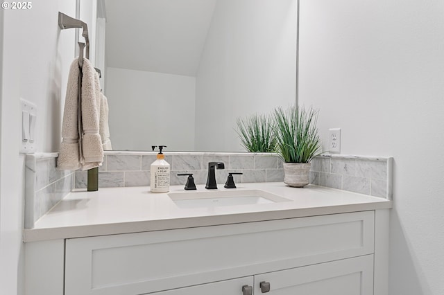 bathroom featuring vanity and backsplash