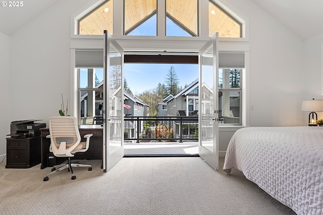 bedroom with access to outside, high vaulted ceiling, multiple windows, and carpet floors