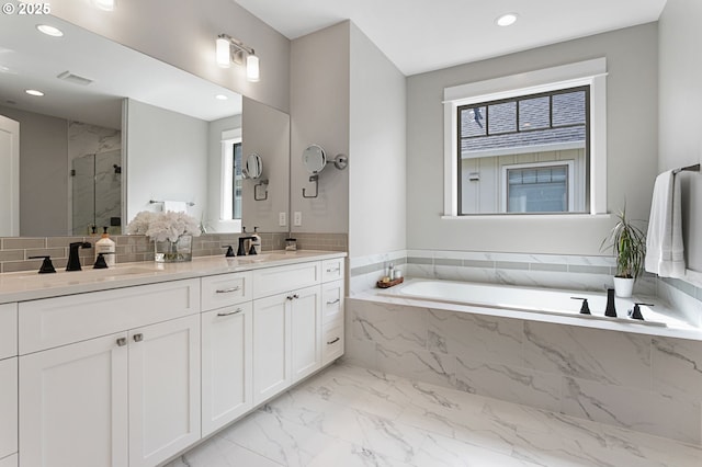 full bathroom featuring a shower stall, marble finish floor, a sink, and plenty of natural light