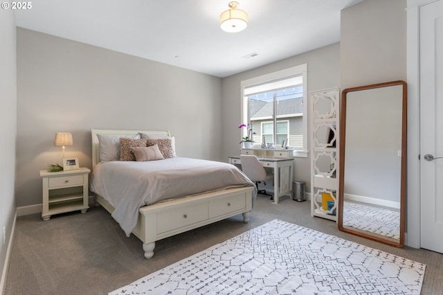 carpeted bedroom with visible vents and baseboards