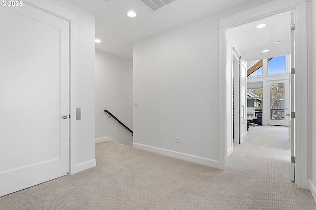 interior space with light carpet, baseboards, visible vents, and recessed lighting