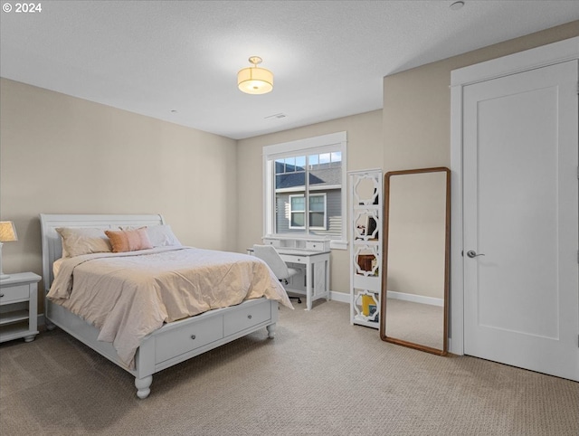 bedroom with baseboards and light colored carpet