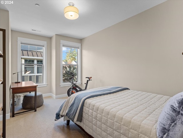 bedroom with carpet, visible vents, and baseboards