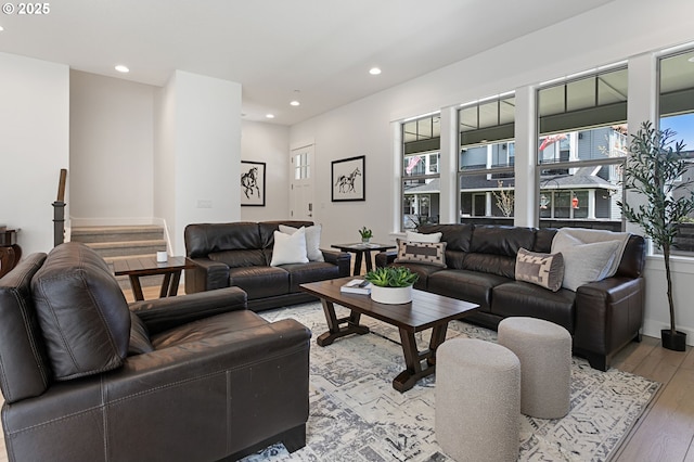 living area with light wood finished floors, plenty of natural light, and recessed lighting