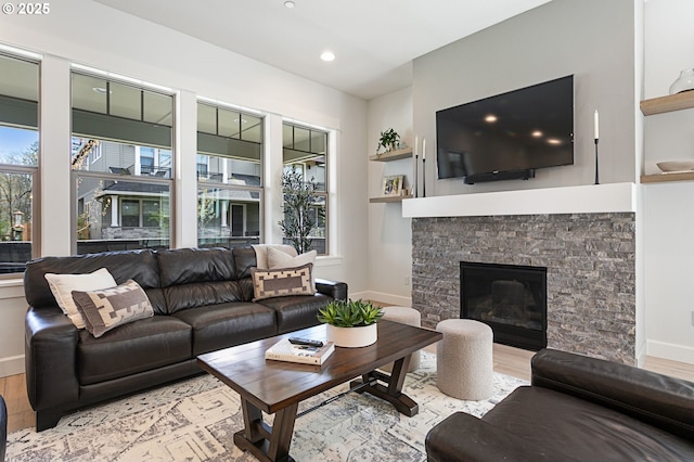 living area with light wood-style floors, baseboards, plenty of natural light, and recessed lighting