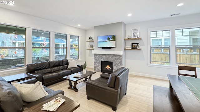 living area featuring a fireplace, visible vents, and recessed lighting