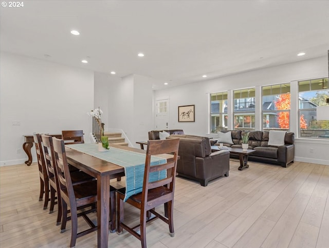 dining area with light wood finished floors, baseboards, stairway, and recessed lighting