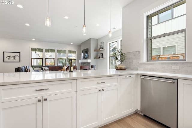 kitchen with light wood-style floors, stainless steel dishwasher, white cabinetry, recessed lighting, and light countertops