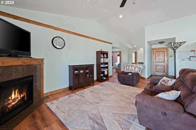 living room featuring a fireplace, lofted ceiling, ceiling fan, and hardwood / wood-style floors