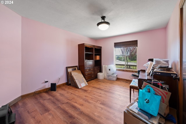 office area with a textured ceiling and hardwood / wood-style floors