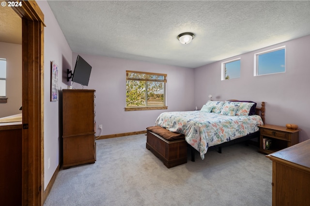 carpeted bedroom featuring a textured ceiling