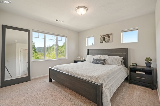 carpeted bedroom with baseboards