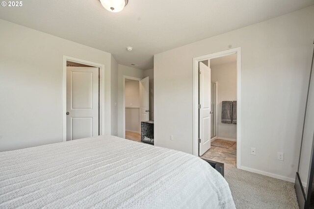 bedroom featuring light carpet and baseboards