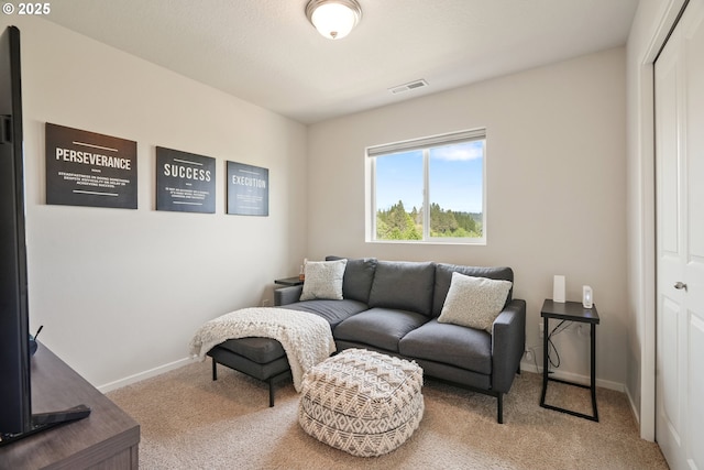 carpeted living room with baseboards