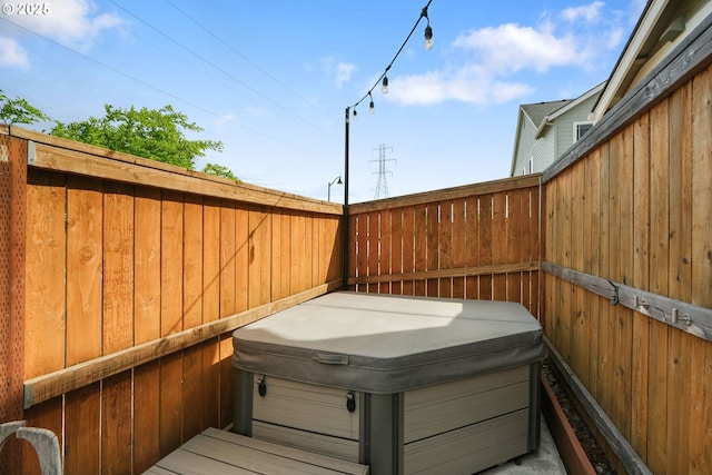 wooden deck featuring a hot tub