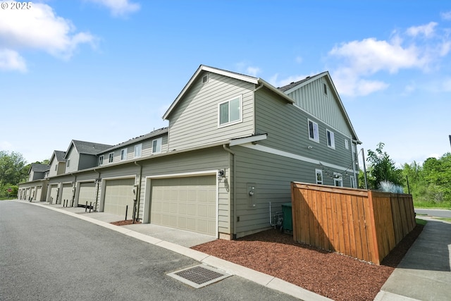 view of side of home featuring fence and board and batten siding