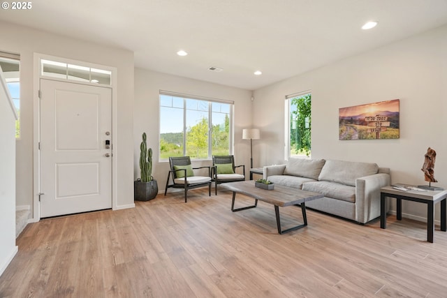 living area featuring light wood-type flooring, recessed lighting, and baseboards
