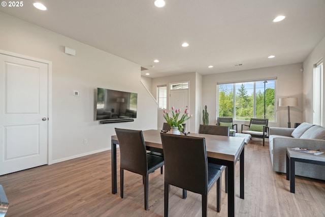 dining room with light wood-style floors, recessed lighting, and baseboards