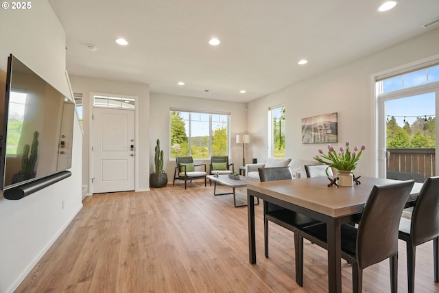 dining room with recessed lighting, healthy amount of natural light, light wood finished floors, and baseboards