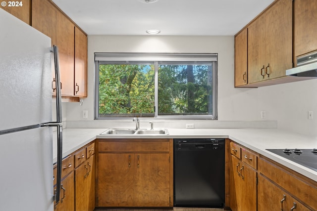 kitchen featuring range hood, black appliances, and sink