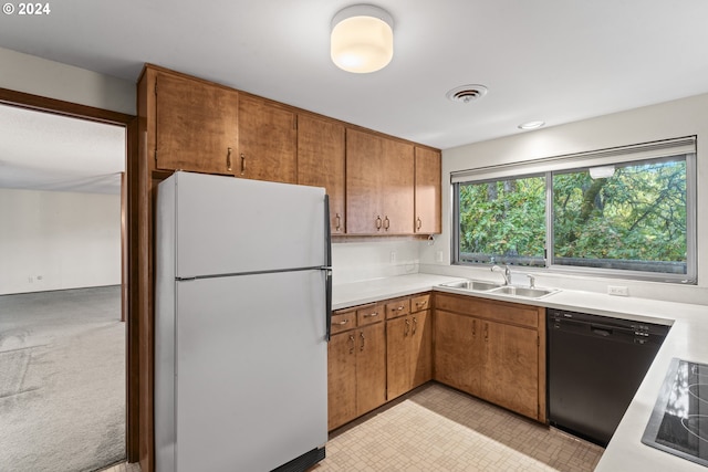 kitchen with light carpet, black appliances, and sink