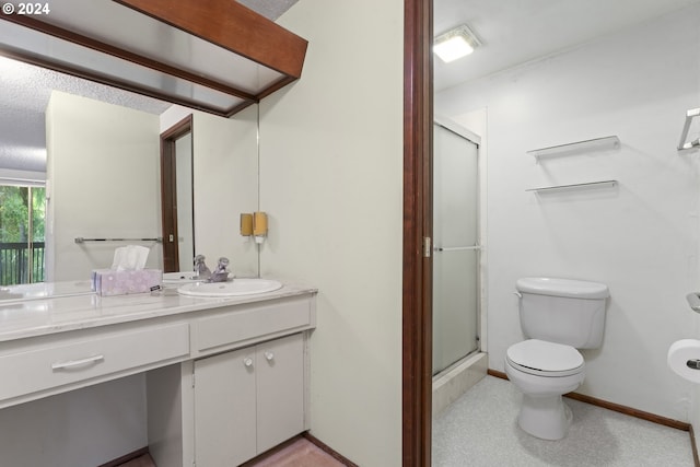 bathroom featuring vanity, a shower with shower door, and toilet