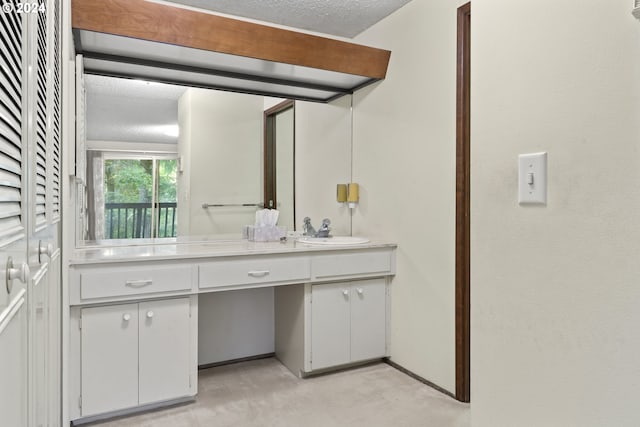 bathroom with vanity and a textured ceiling