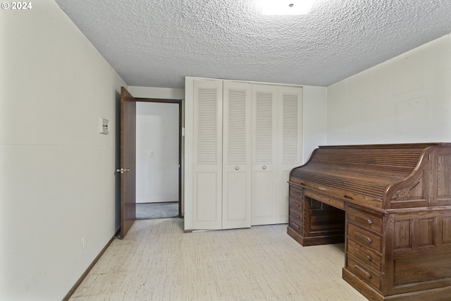 office featuring a textured ceiling and light wood-type flooring