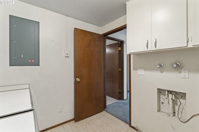 laundry area with light carpet and electric panel