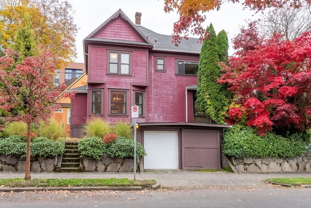 victorian-style house with a garage